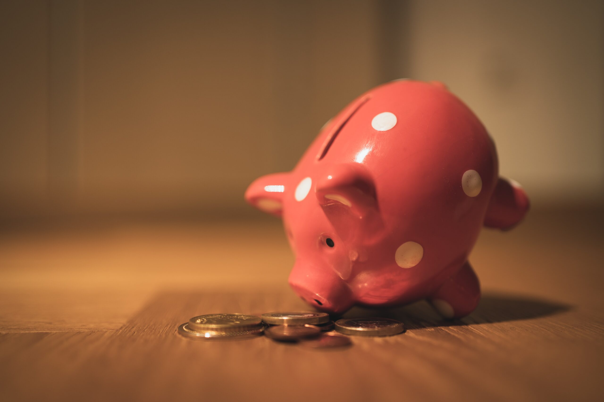 Piggy bank tipped to side with change spilling out