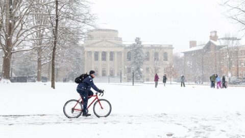 Student bikes across the quad